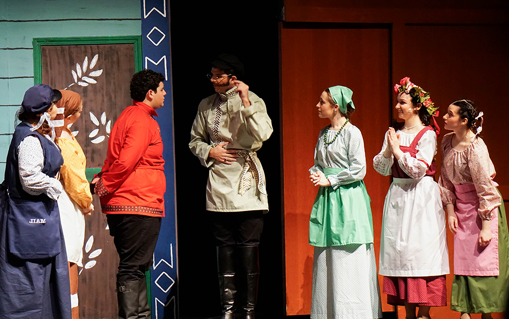 Students on stage performing a play